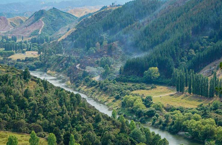A valley with a river running through bush-clad banks.