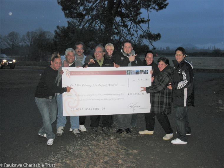 Group of people holding a massive cheque.