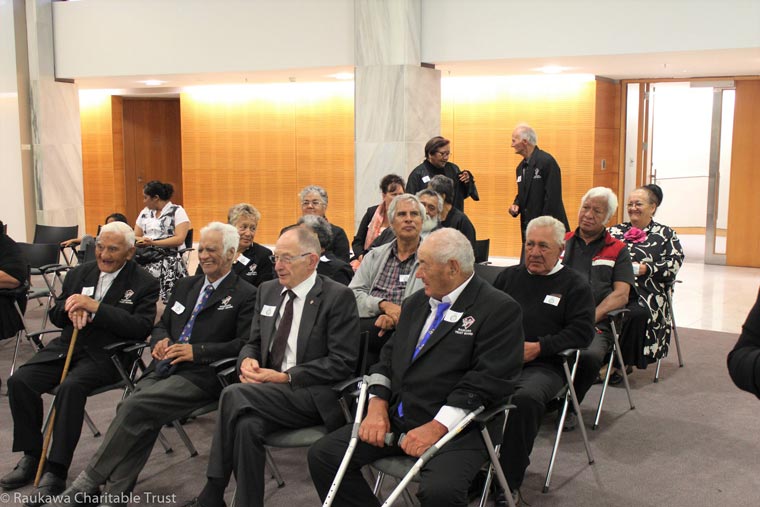 Group of seated kaumatua listening to an unseen speaker.