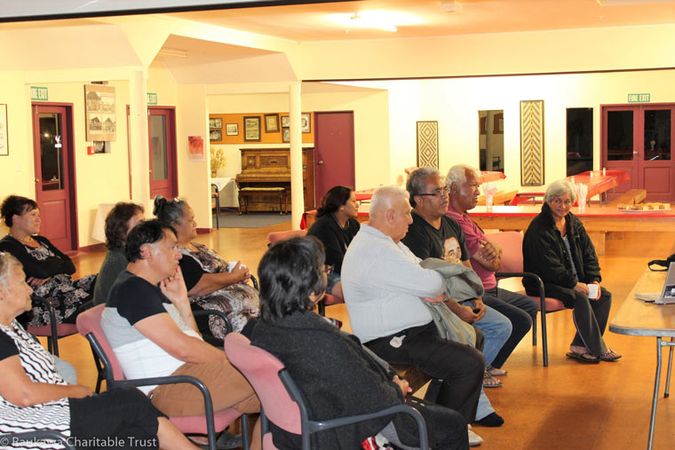 Group of kaumatua and kuia listening to an unseen speaker.