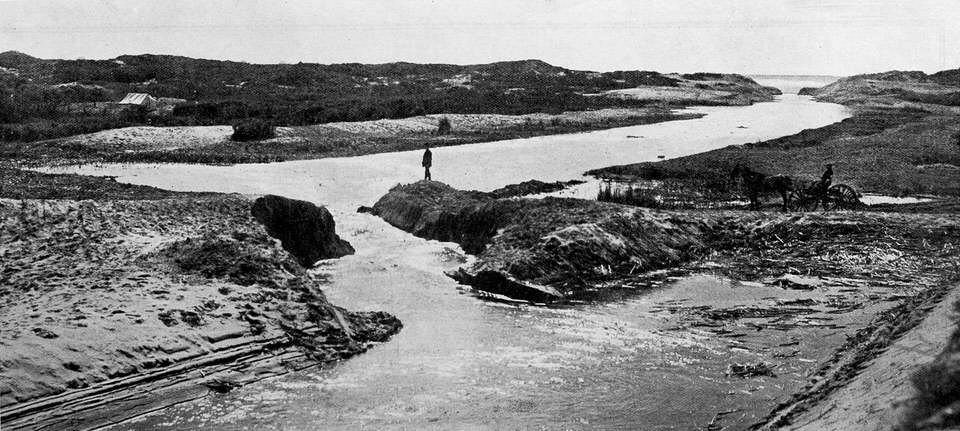 Draining the great Rangataiki swamp,the first water through a temporary cut from the Rangataiki river to the sea.