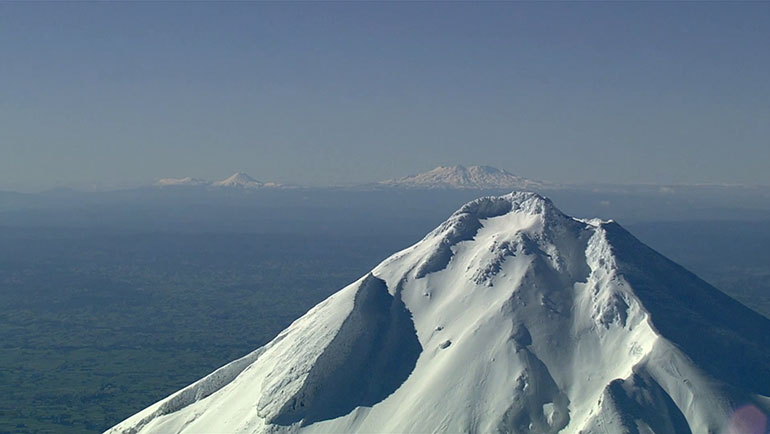Top of mountain against the sky with other mountains in background
